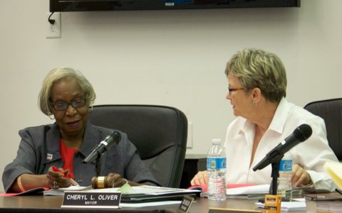 (Left to right) Selma town councilwoman Jacy Lacy discusses a resolution concerning Smithfield and Selma area schools with Mayor Cheryl Oliver prior to a 4-1 vote to approve the resolution Tuesday night. WTSB Photo