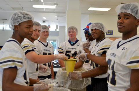 Anxious to reach their goal, Smithfield-Selma High School football players (from left) Damonte Morrison, Patrick Costanzo, Jordan Watson, Chandler Parrott, Tyrek Christmas, Tyree Minor, and Rae’son Watson teamed up to help the Raleigh-based International Organization “Stop Hunger Now” combat hunger world-wide.