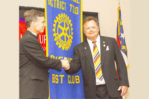 Matthew Kane, District 7710 governor (left) presents John Long Clayton Rotary Club President with the 2015 Best Club Banner. Photo by Ed Shearin