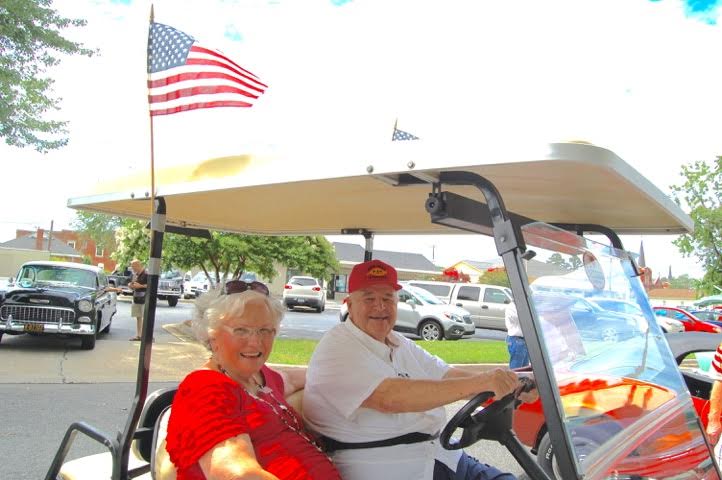Even the golf carts were patriotic on Saturday in Benson for the town’s 15th annual Independence Day celebration. In the photo, Billy and Linda Massengill, parents of Benson Mayor William Massengill, pull up to the Singing Grove with a couple of flags flying.
