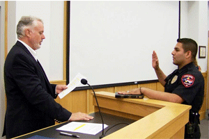 (Left to right) Smithfield Mayor John Lampe swears in Officer Miguel Renteria. WTSB Photo