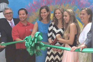 (Left to right) Johnston County Commissioner Jeff Carver, Smithfield Mayor Pro-Tem Andy Moore, Girl Scout Troop 3424 Leader Jennifer Gaskins, her daughter Sarah Gaskins, Clar McGeough, and her mother Elizabeth McGeough cut the ribbon at the new Neuse River Greenway Mural in Downtown Smithfield.
