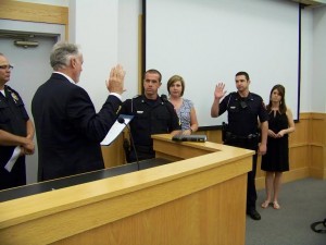 Mayor John Lampe (left) administered the new oaths to Officers Brian O'Branovich (center) and David Johnson (right) on Tuesday night.