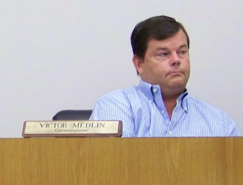 Four Oaks Commissioner Vic Medlin listens to testimony during a solar farm public hearing Monday night. WTSB Photo