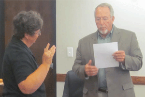 Mayor Mike Gordon (far right) swears in Lisa Barnes as the interim town clerk following the resignation of Jean Overton.