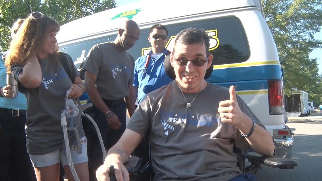 Jason Palmer gives a thumbs up to his supporters Saturday after raising $27,000 for the Johnston County EMS paramedic diagnosed with ALS.