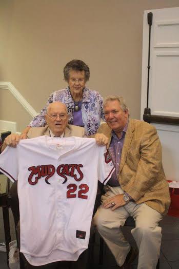 (Left to Right – Front) Bill Perry shows off a Carolina Mudcats jersey given to him by Mudcats owner Steve Bryant, during a surprise 90th birthday party on Sunday. Perry and his wife, Vertie (center) have been married for 64 years.