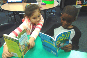 Selma Elementary second grade students (from left) Dulce Meza and Dennis George Jr. enjoy new books that their teacher, Alexis LeRoy, received through DonorsChoose.org.
