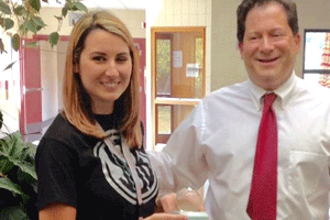 Jerica Sittig (left) receives the Crystal Apple Award. Standing with her is Selma Middle Principal John Bell. Contributed photo