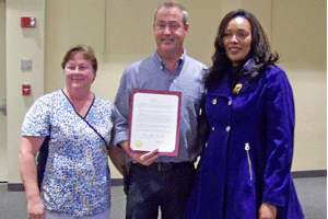Clayton Mayor Jody McLeod presents a proclamation naming Oct. 17 at Clayton Band Classic Day to Beverly Erwin Vice President of the Clayton High Band Boosters (right) and Deb Williams chairman of the Clayton Band Classic (left).