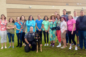 Clayton Police Officer Justin Vause and K-9 Officer “Major” visit Corinth Holders High School. On the back row (from left) are Sydney Reeder, Jessi Barber, Katie Riker, Julia Dolinshek, Rebecca Parker, Hannah Bober, Shelby Sampson, Heather Kirby, Blayne Pearce, Paris Tant, Autumn Wright, Brandon McCurdy, Courtney Kauffman, Tim Johnson, and Austin Morgan. On the front row are Officer Justin Vause and Major.