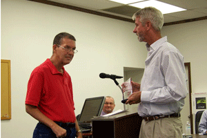 Tim Hughes (left) accepts a crystal trophy from Selma Director of Parks and Recreation Joe Carter (right) for being named the 2015 Selma Railroad Days Grand Marshal. Even though the Railroad Days festivities, including the parade, were rained out earlier this month, the Town still wanted to honor and recognize Hughes. WTSB Photo