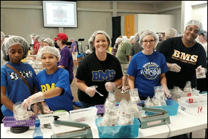 Members of the Benson Middle School PEARLS, a club for mentoring young girls, work with the community on Oct. 24, to help prepare food for the Stop Hunger Now Campaign. Working together (from left) are Tianna Hicks, Skyler Miller, Amy Toler, Meghan Billings, and Marilyn Bailey.