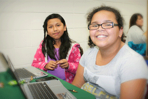 West Smithfield Elementary students (from left) Sherlyn Ortiz and Stefani Robeson present their weather comics at the JCS Digital Learning Expo.