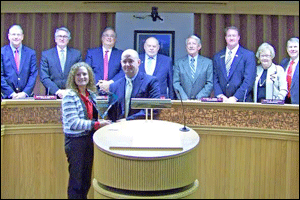 (Front) (Left to Right) Kelly McIver, Executive Director of the NC Sweet Potato Commission based in Benson and Bryant Spivey, Director of Johnston County Cooperative Extension pose with the Industrial Appreciation Award. Standing in the background are Johnston County Commissioners and County Manager Rick Hester