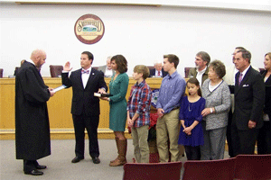 Mayor Andy Moore receives his oath of office from Superior Court Judge Thomas H. Lock.