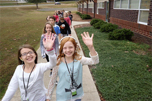 River Dell Elementary fifth graders Molly Nall (left) and Morgan Ellis (right) lead their class as they walk and learn.