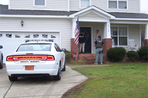 A Johnston County deputy, US Marshal, and NC Probation Officer check an address Tuesday morning on Southfort Drive in the Cleveland community for a registered sex offender. WTSB Photo