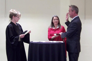 Clayton Mayor Jody McLeod receives his oath from District Court Judge Mary Wells.