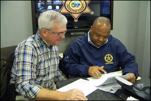 (Left to right) Sheriff Steve Bizzell and Scott J. Parker, US Marshal for the Eastern District of North Carolina, review a list of registered sex offenders in Johnston County inside the Johnston County Sheriff’s Office Mobile Command Post Tuesday morning. WTSB Photo