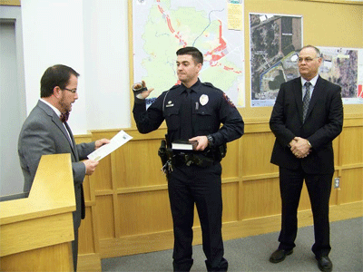 (Left to right)  Mayor Andy Moore gives the Oath of Office to Smithfield's newest police officer Tyler Hayes as Police Chief Michael Scott looks on. WTSB Photo