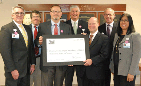 The Atlantic Coast Pipeline Community Investment Program has awarded a $10,000 grant to the Johnston Health Foundation to support its campaign to purchase two 3-D mammography systems. At center, (right to left), foundation chair David Mills accepts the check from Bruce McKay, senior energy policy director for Dominion, which is one of the four energy companies developing the proposed pipeline. From left, others present were: Jeff Carver, a Johnston Health board member; Stewart McLeod, a foundation board member; Bobby Parker, chair of the Johnston Health board; Chuck Elliott, CEO and president of Johnston Health; and Sol Halliburton, director of the foundation.