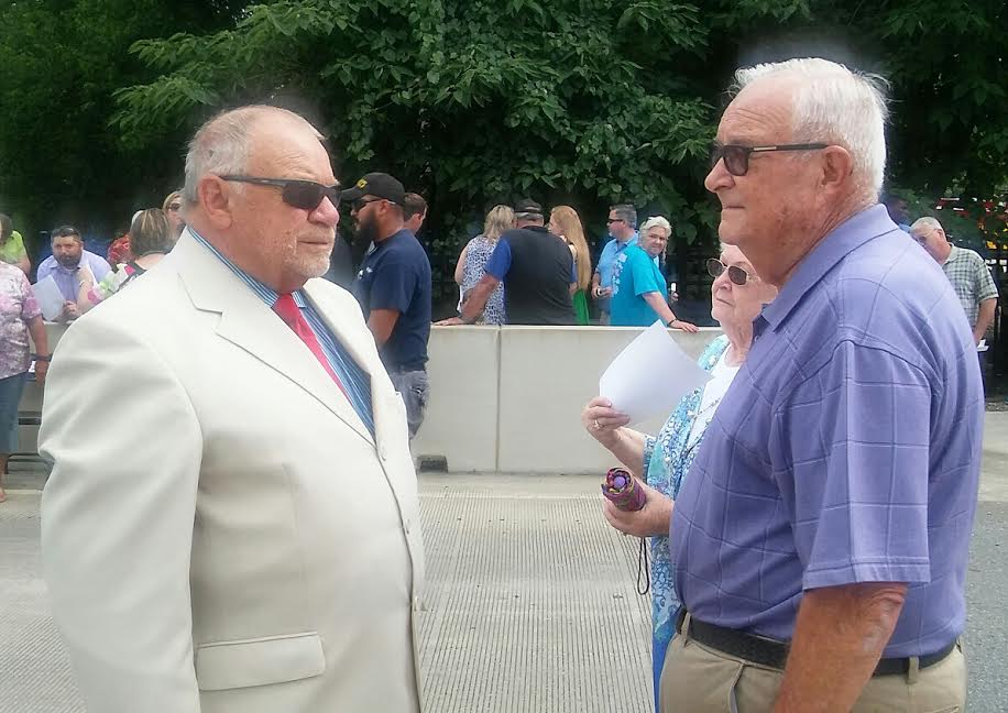 Retired Deputy Sheriff Jimmy Doan (right) meets Johnston County Commissioner Chairman Tony Braswell at Friday’s ceremony. Doan worked with Deputy West on the Johnston County Sheriff’s Office.