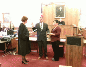 Newly-elected County Commissioner Larry Wood takes his Oath of Office from District Court Judge Caron Stewart. JoCoReport.com Photo