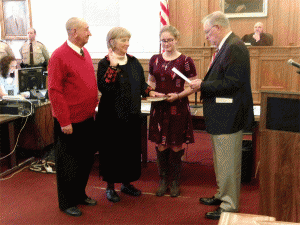 Dr. Peggy Smith takes her new Oath of Office from Representative James H. Langdon. Smith recently won re-election to her third term on the Johnston County School Board. JoCoReport.com Photo