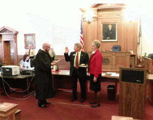 Commissioner Ted Godwin receives his Oath of Office from Resident Superior Court Judge Thomas Lock. Godwin was elected in November to his second term. JoCoReport.com Photo